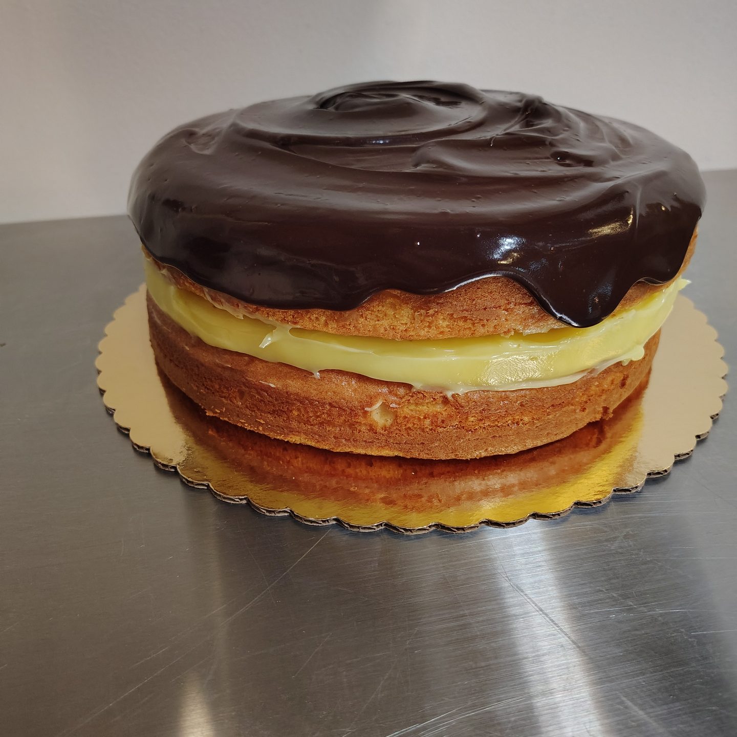 A Boston cream pie layered with custard and topped with chocolate ganache