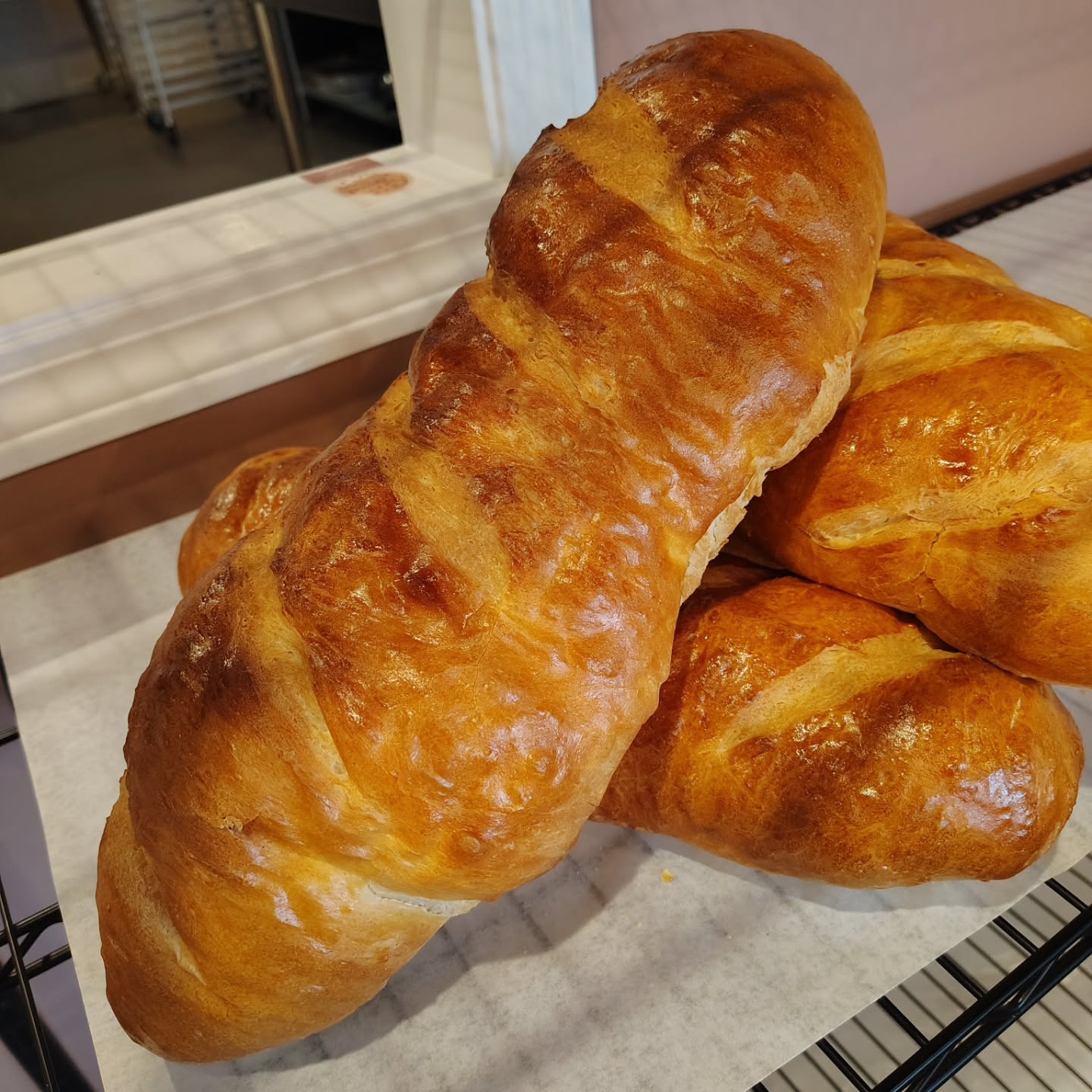 Golden loaves of fresh bread on the rack