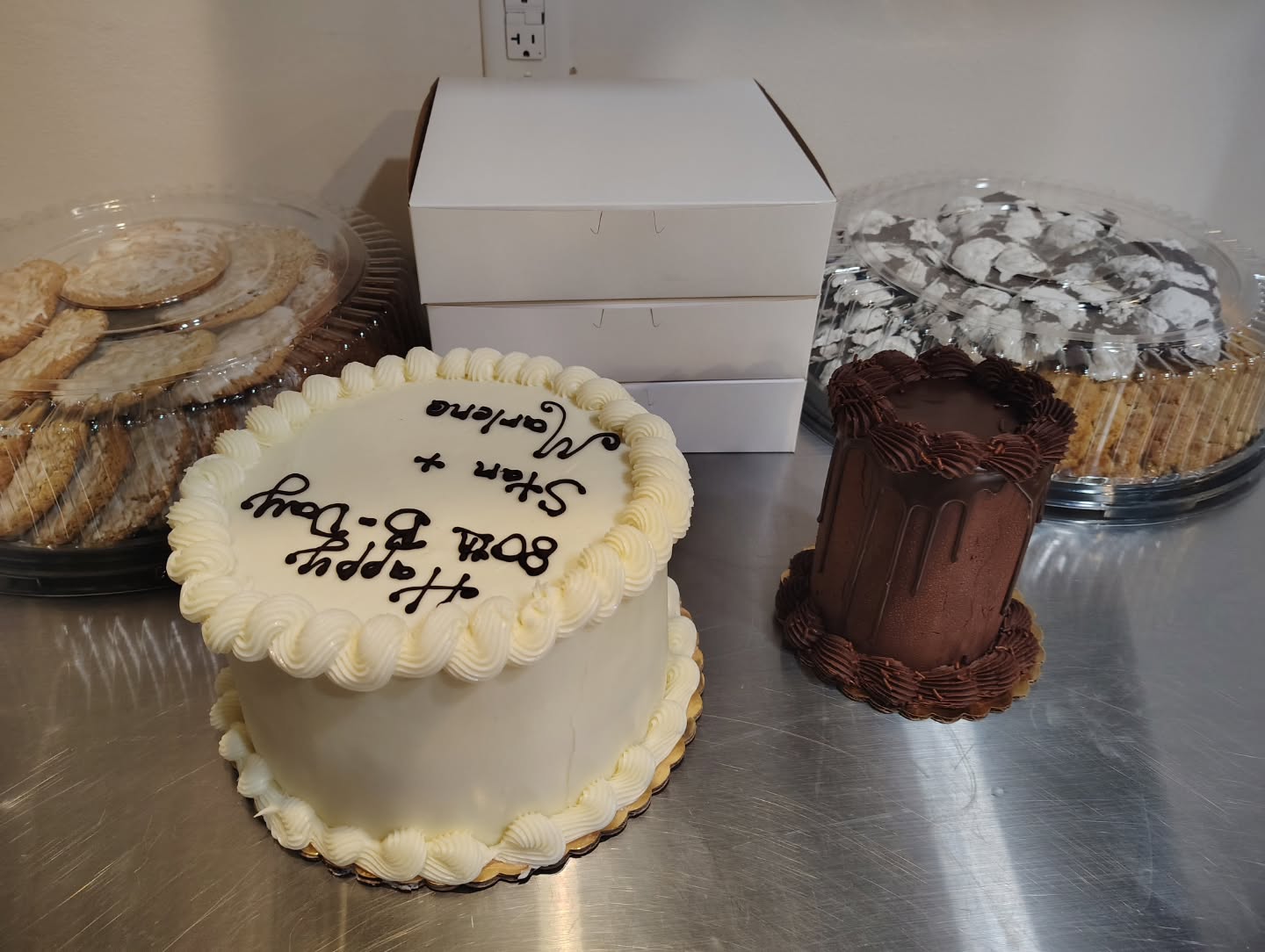 Buttercream and chocolate decorated cakes on the counter