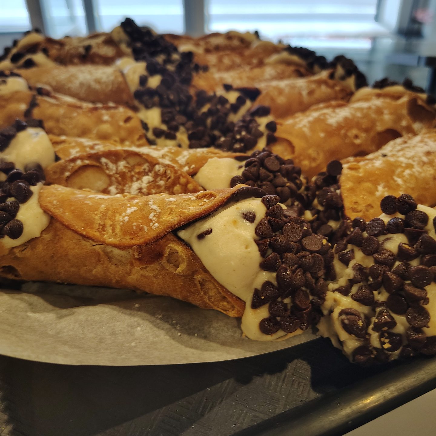 Cannoli filled with sweet ricotta and dipped in chocolate chips