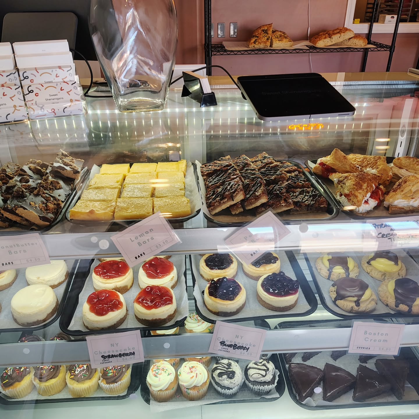 The Sweet Shenanigans display case full of bars, cheesecakes, cookies and cupcakes